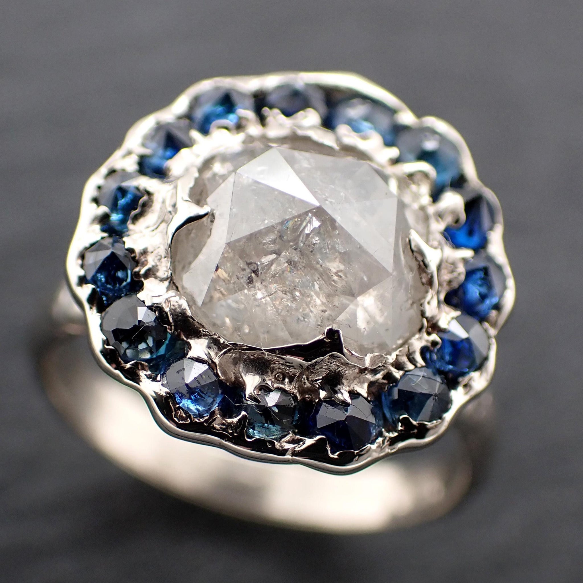 Handcrafted 14k white gold engagement ring.A 2.145 ct diamond with sapphire halo. A timeless peice of wedding elegance.A statement ring!3582