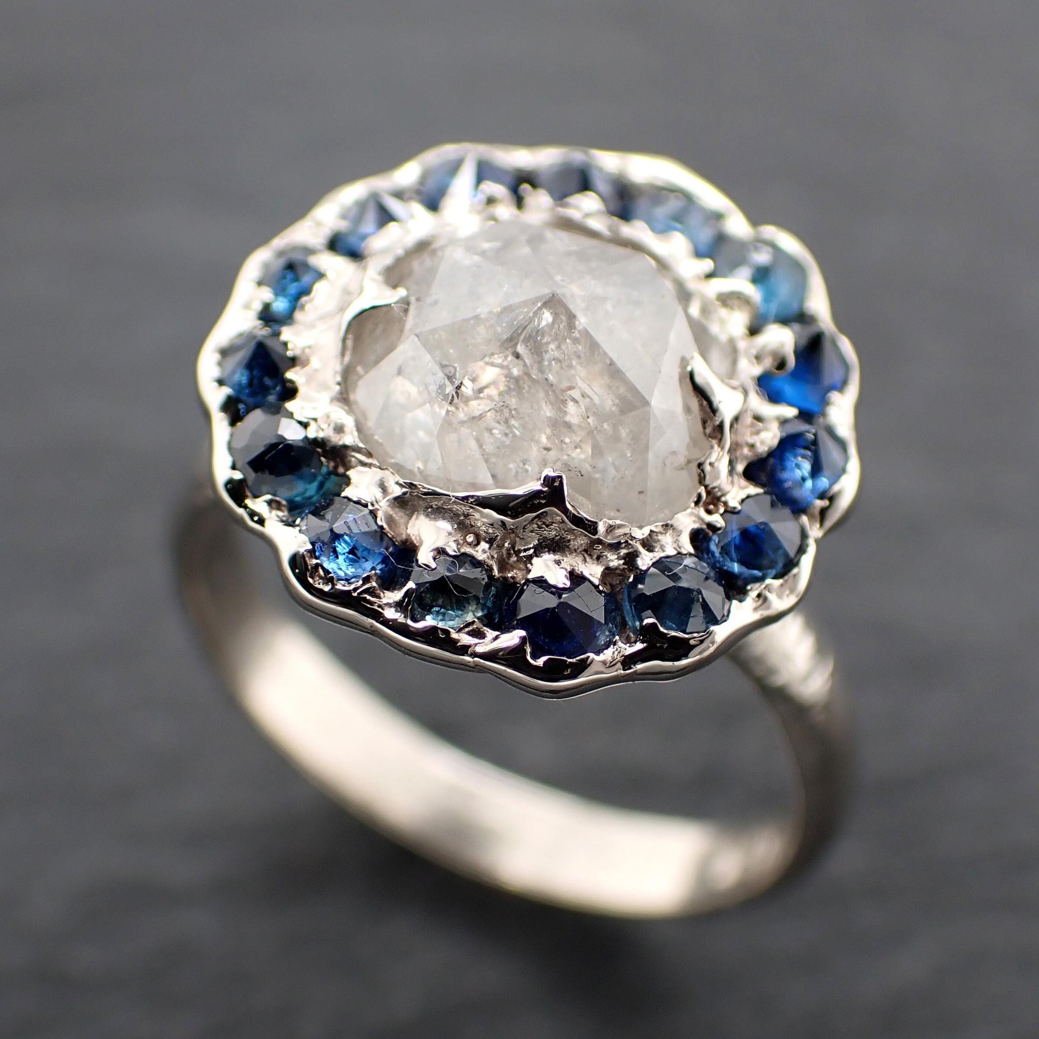 Handcrafted 14k white gold engagement ring.A 2.145 ct diamond with sapphire halo. A timeless peice of wedding elegance.A statement ring!3582