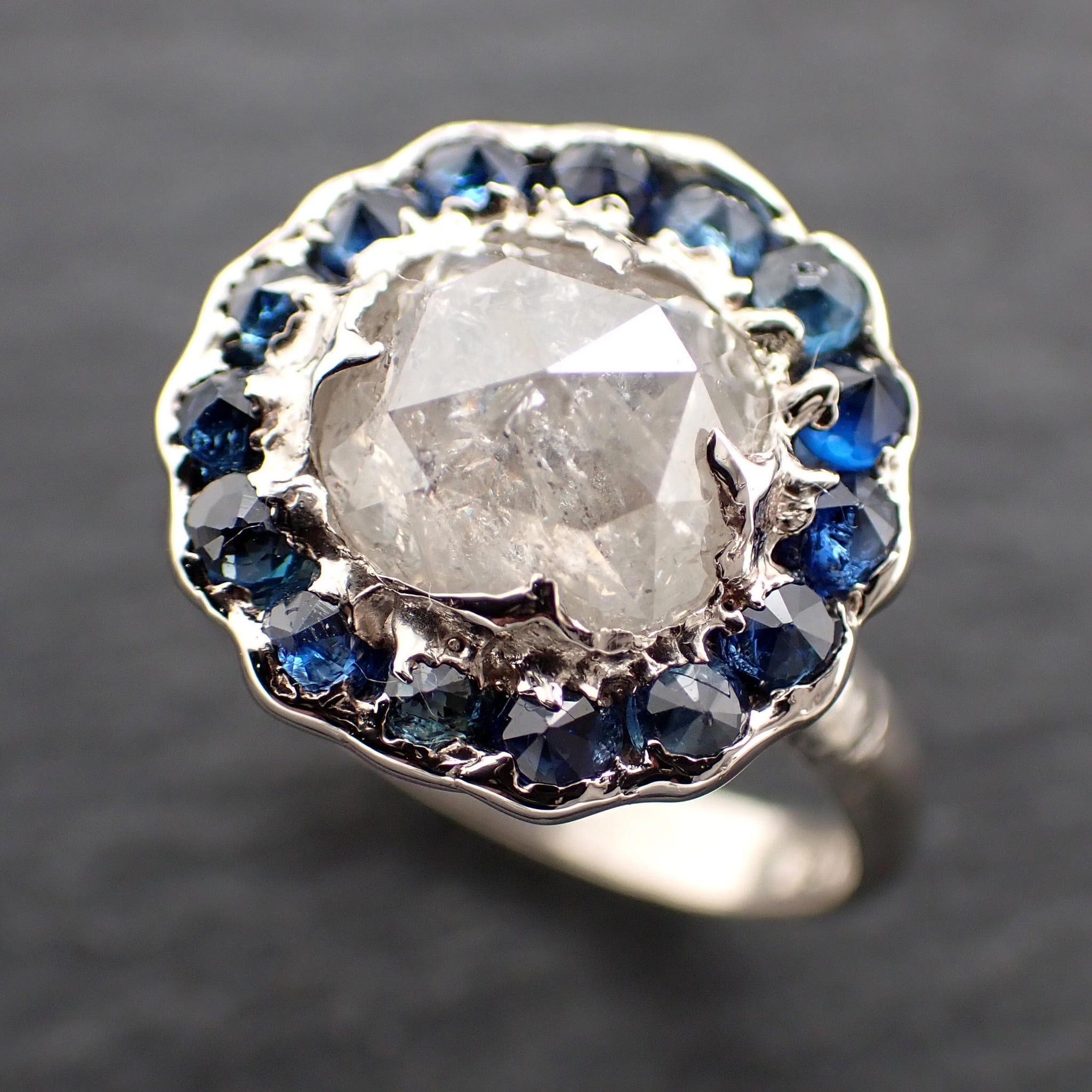 Handcrafted 14k white gold engagement ring.A 2.145 ct diamond with sapphire halo. A timeless peice of wedding elegance.A statement ring!3582