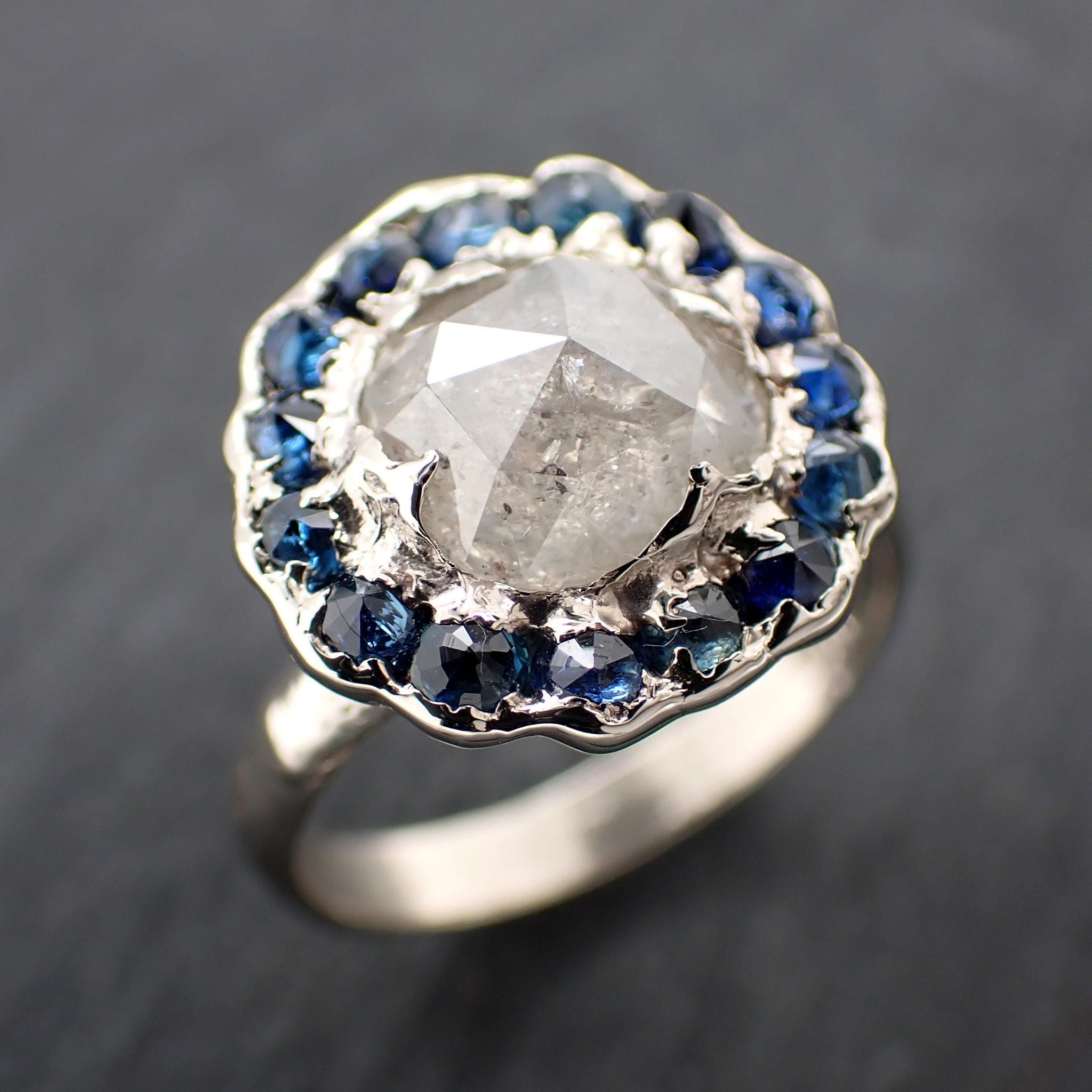 Handcrafted 14k white gold engagement ring.A 2.145 ct diamond with sapphire halo. A timeless peice of wedding elegance.A statement ring!3582