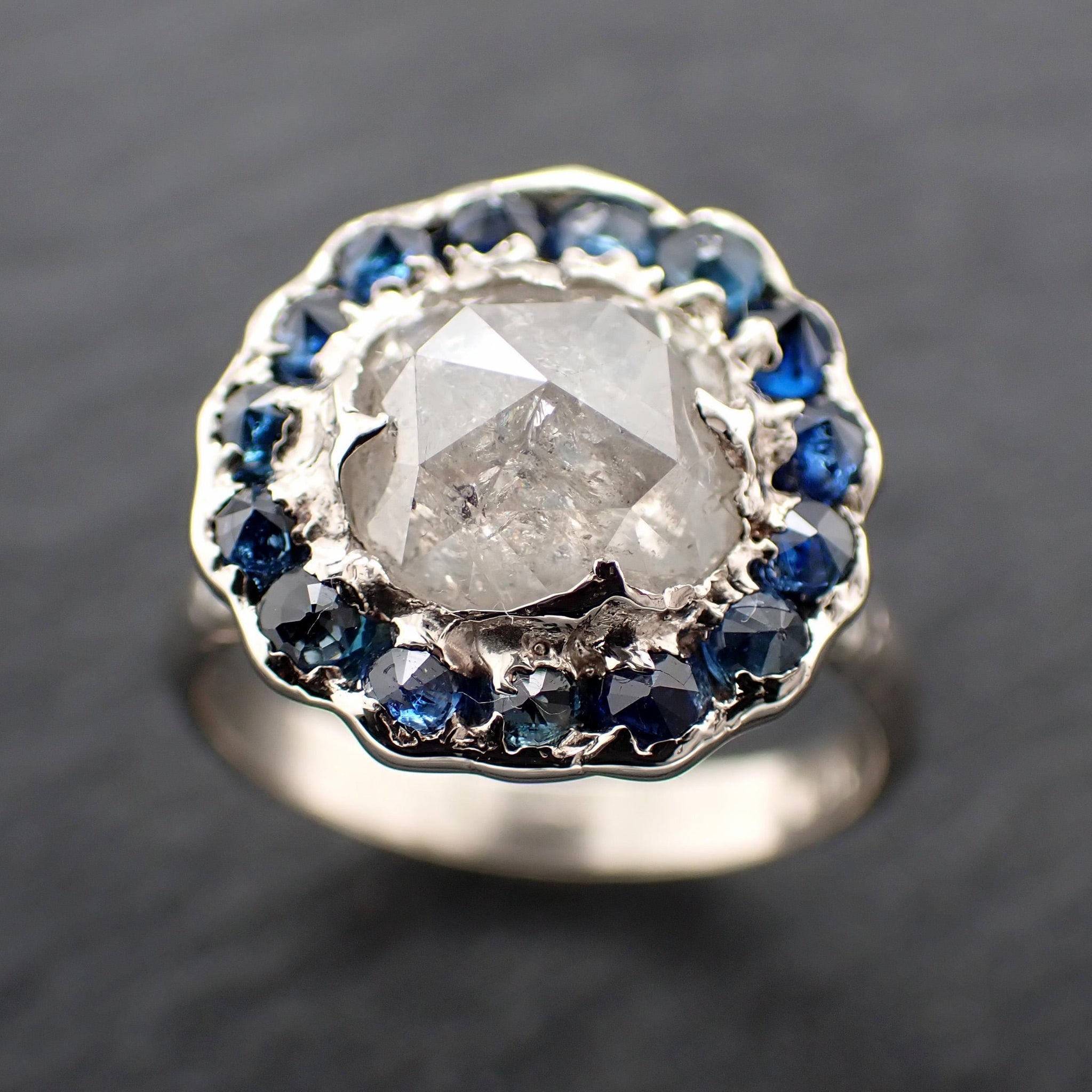 Handcrafted 14k white gold engagement ring.A 2.145 ct diamond with sapphire halo. A timeless peice of wedding elegance.A statement ring!3582