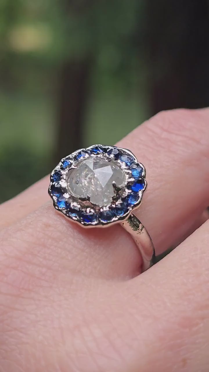 Handcrafted 14k white gold engagement ring.A 2.145 ct diamond with sapphire halo. A timeless peice of wedding elegance.A statement ring!3582